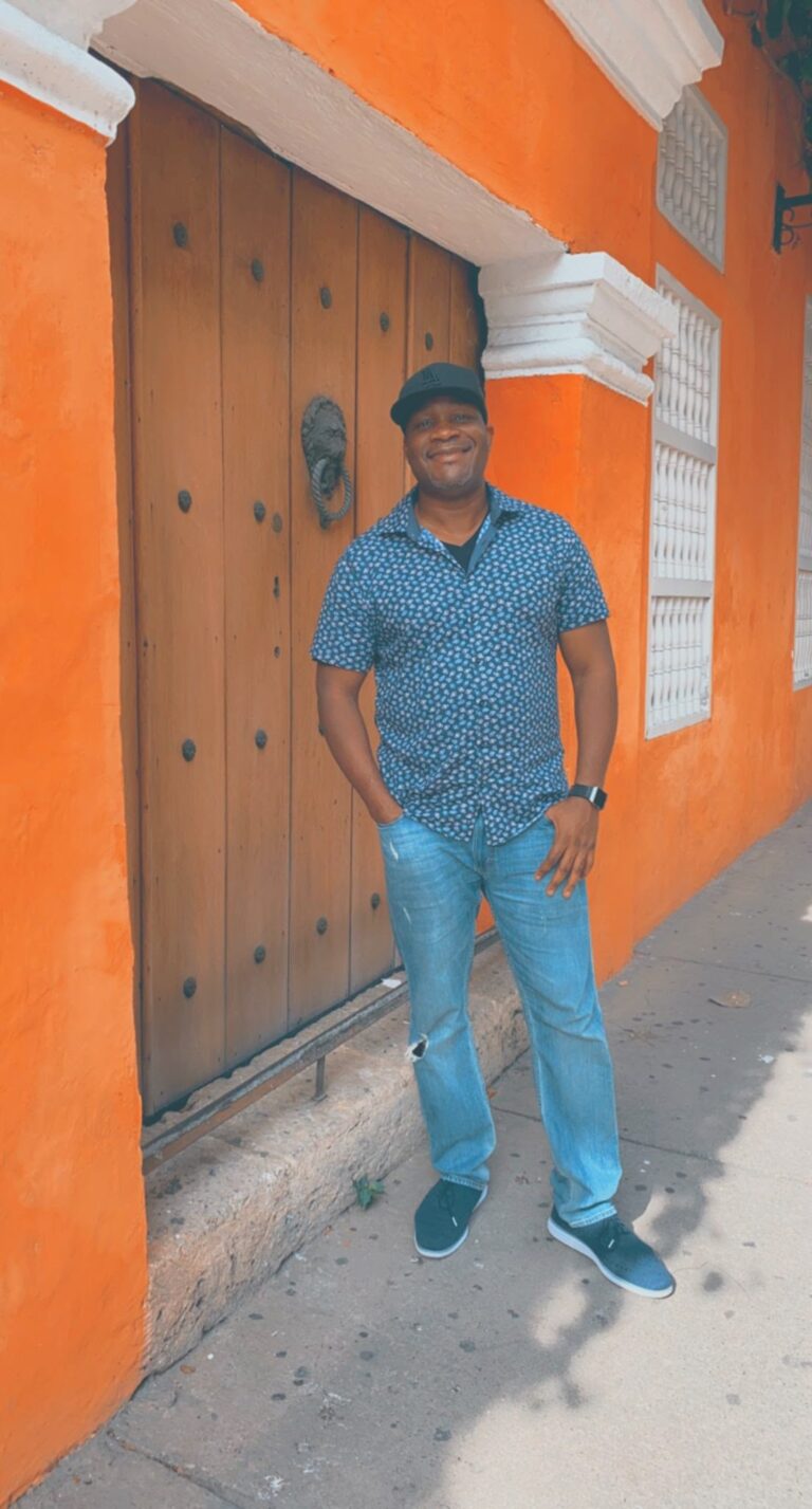 Shep in a doorway on a street in the walled city of Cartagena