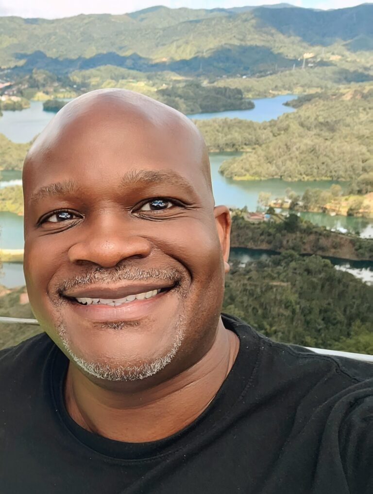 Shep in front of the water at Guatapé, Antioquia
