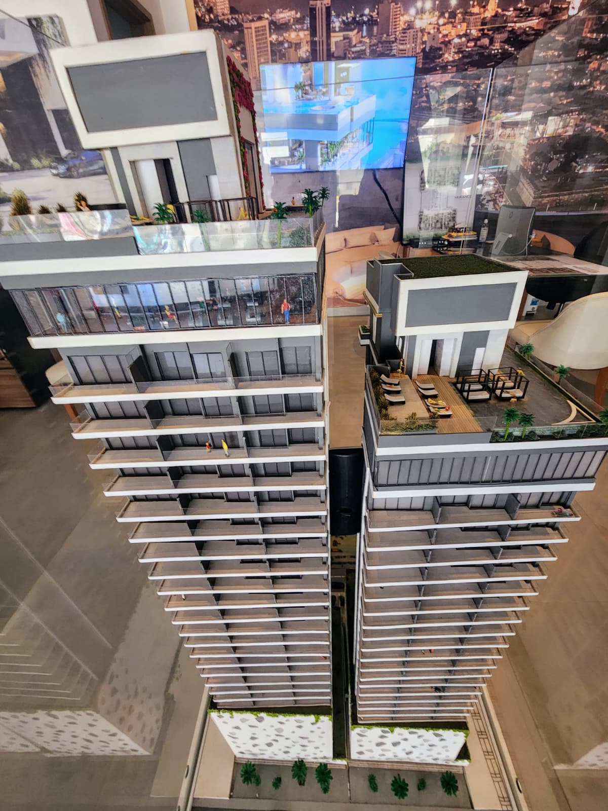 A pre-construction apartment-tower scale model in a Colombian developer's sales showroom