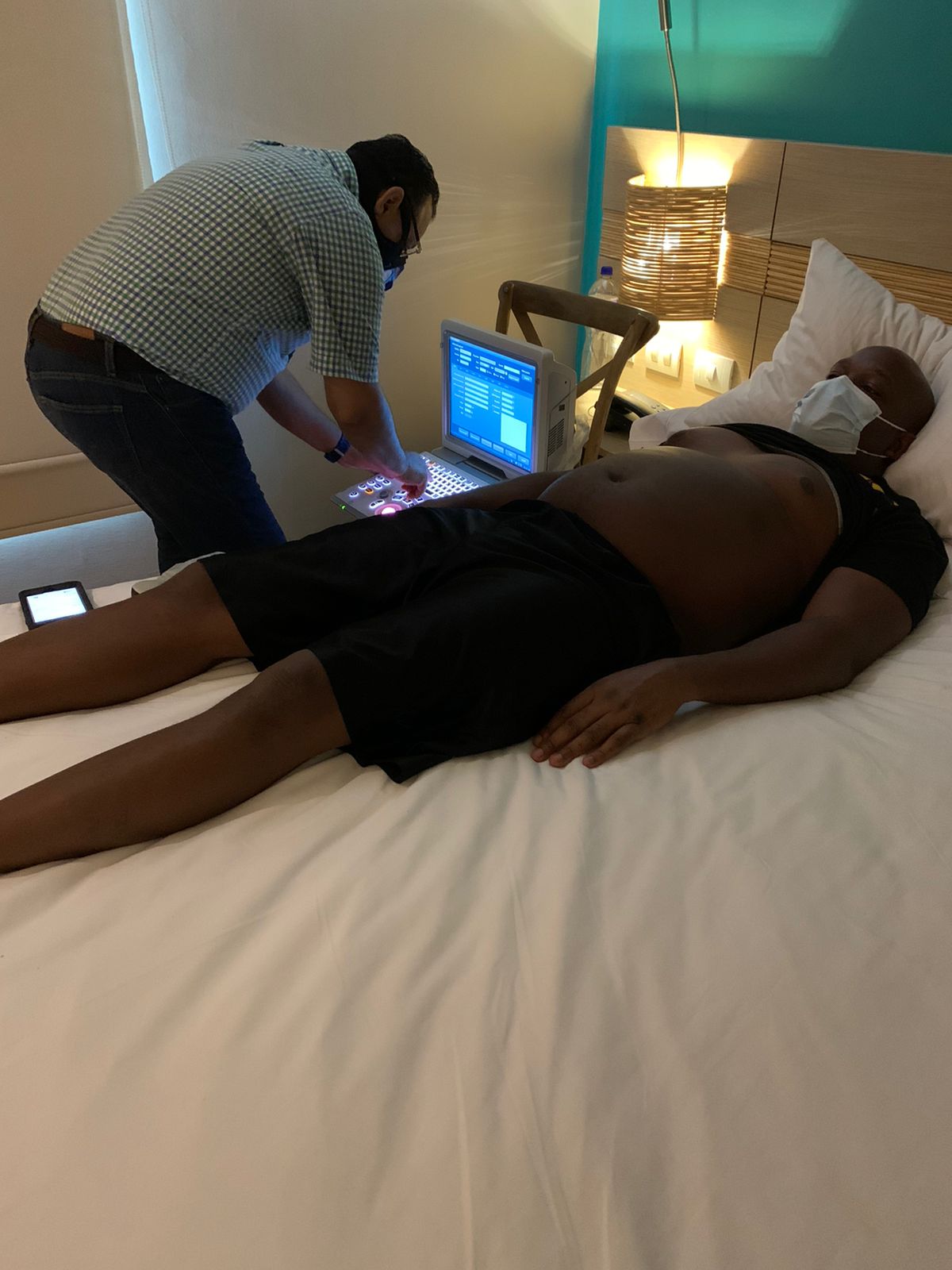 Shep receiving a portable ultrasound scan at his hotel in Colombia